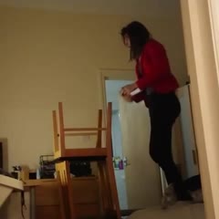Girl Falls While Standing on Two Chairs to Change Lightbulb