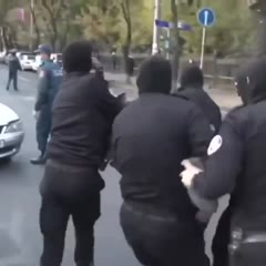 Man singing "I believe I can fly" while being carried by the cops