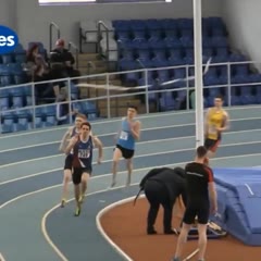 Runner gets tangled up in pole vault crossbars at the final stretch of race.
