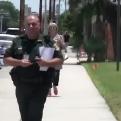 Putting on my seatbelt as I walk by police