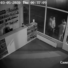 Angry woman headbutts a shop window