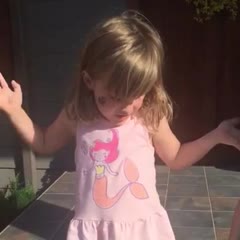 A little girl has drawn a family of giraffes on a stair at the entrance of a house