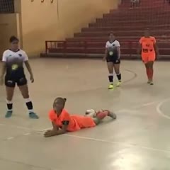 Brazilian woman soccer / futsal player kicks in the neck
