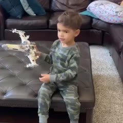 Running to show mom his finished LEGO X-Wing