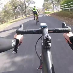 Cyclists are taken out by a car coming around the corner