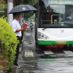 Man Stands on the Roadside with a Brick in Hand on a Rainy Day