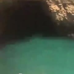 He jumps off a cliff and lands by mistake on a boat