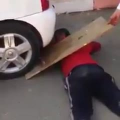 Dumbass almost gets his head crushed by his friend's car